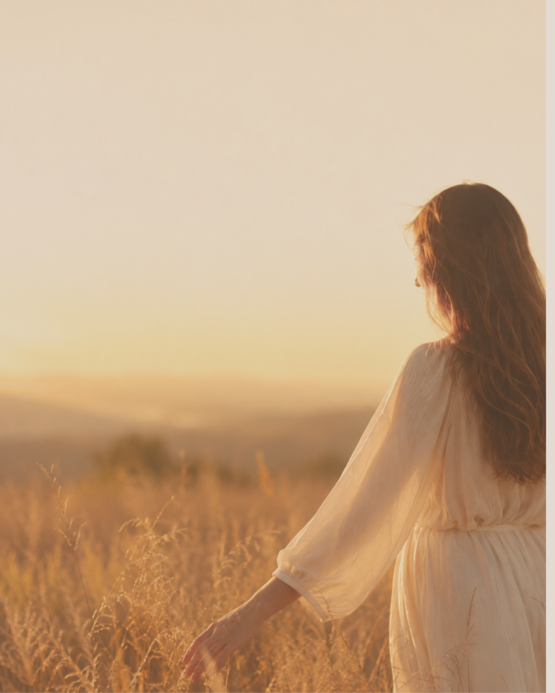 Woman looking across coastal countryside in the evening light